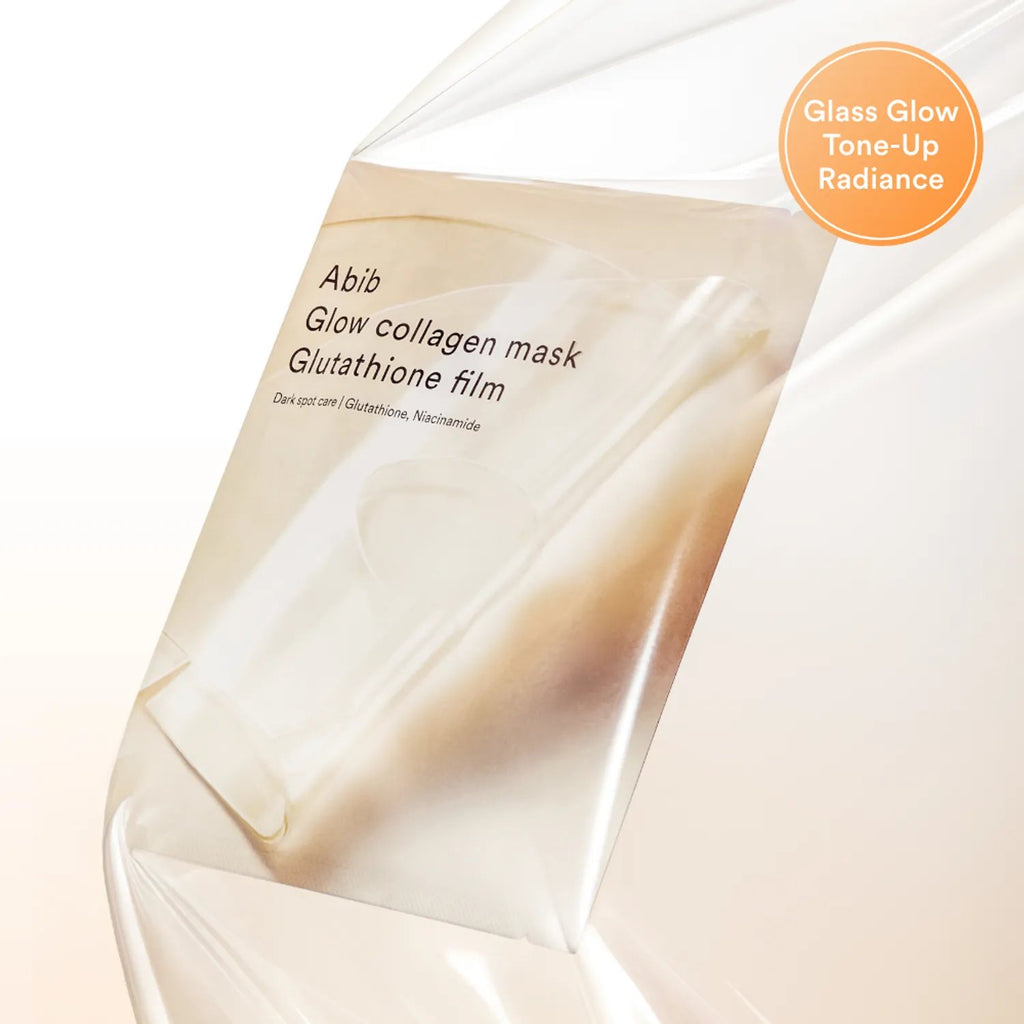 A close-up of a translucent glass skincare mask package labeled 'Abib Glow collagen mask Glutathione film' with an orange circular badge reading 'Glass Glow Tone-Up Radiance' on a soft white background.